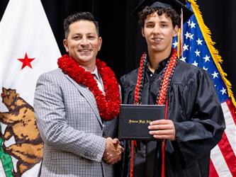 futures principal posing with graduating student