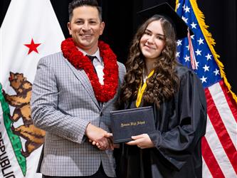 futures principal posing with graduating student