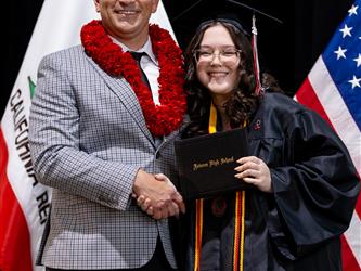 futures principal posing with graduating student