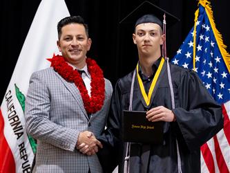 futures principal posing with graduating student