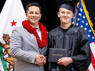 futures principal posing with graduating student