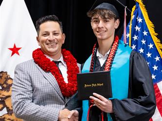 futures principal posing with graduating student