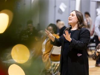 Woman conducting singers