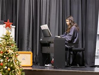 Girl playing piano on stage
