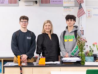 teacher posed with two students