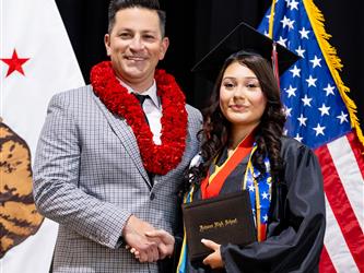 futures principal posing with graduating student