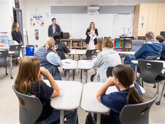 guests listening to speaker in class