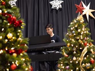 Piano player with christmas trees in foreground