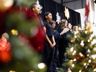 Student singers with christmas trees