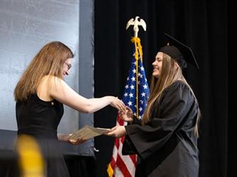 Graduate shaking hands