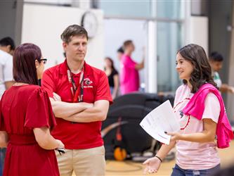 student speaking with staff