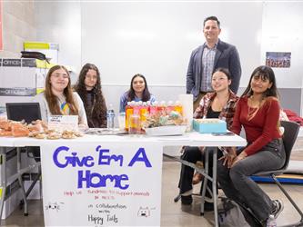 students posing at table