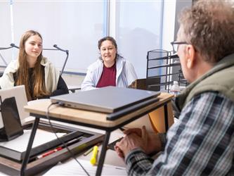 students laughing with teacher 