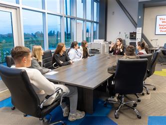 students gathered at conference table 