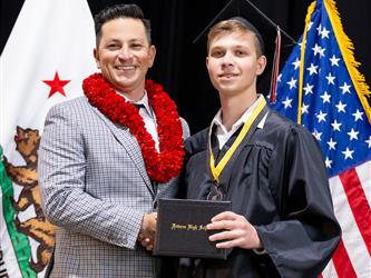 futures principal posing with graduating student