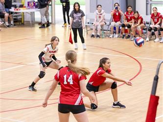 Futures Girls Volleyball team setting the ball