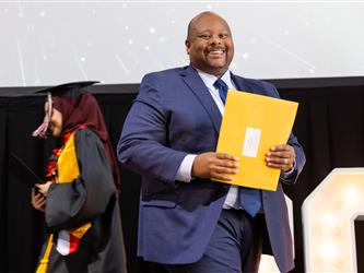 two students walking to stage