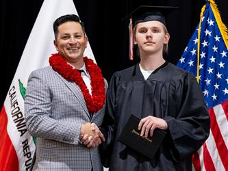 futures principal posing with graduating student