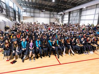 futures principal shaking hands with graduating student