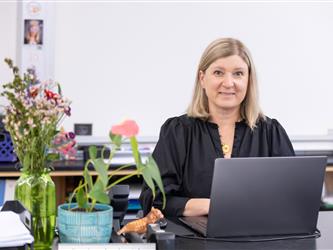 staff sitting with laptop 