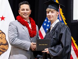 futures principal posing with graduating student