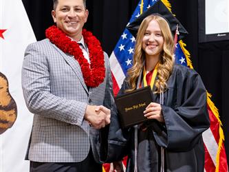 futures principal posing with graduating student