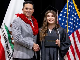 futures principal posing with graduating student