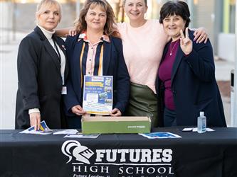 Futures staff are posed at the open house entrance table