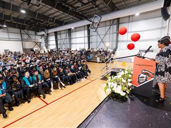 futures principal shaking hands with graduating student