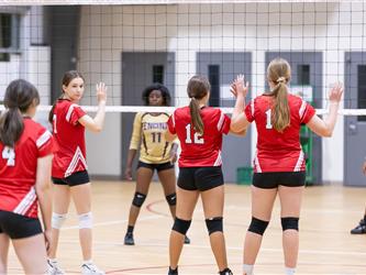 Futures Girls Volleyball team hands up