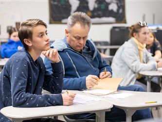 guests listening to speaker in class