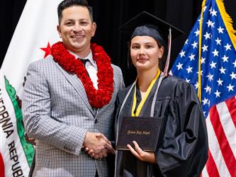 futures principal posing with graduating student