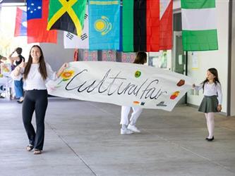 Two girls holding welcome sign