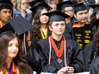 wide shot of speaker to grad class