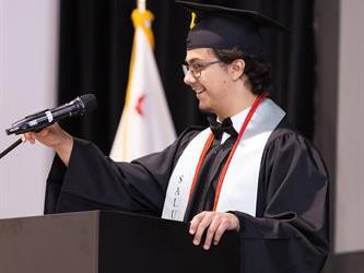 Graduate speaking at mic