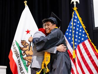 futures principal posing with graduating student