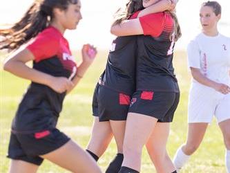 Soccer players hugging
