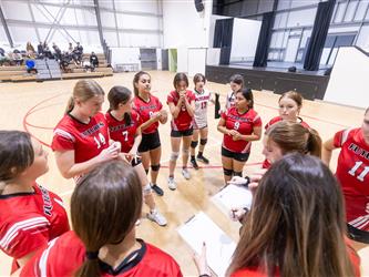 Futures Girls Volleyball team in huddle