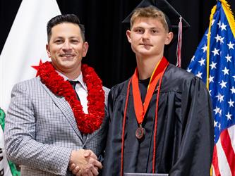 futures principal posing with graduating student