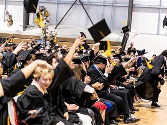 Graduates flipping hats