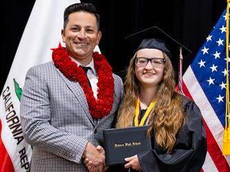 futures principal posing with graduating student