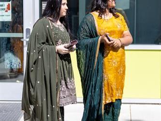 Two women in cultural gowns