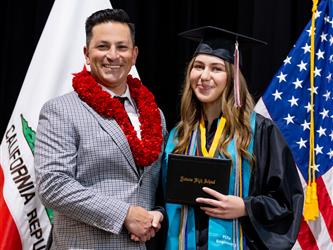 futures principal posing with graduating student