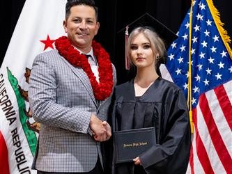 futures principal posing with graduating student