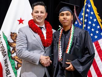 futures principal posing with graduating student