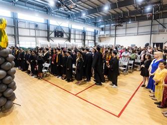 Graduates standing in gym