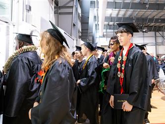 futures principal shaking hands with graduating student