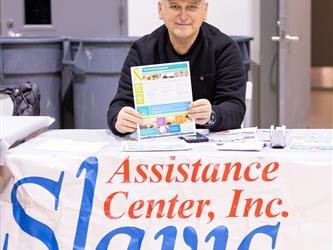 Person sitting at table holding flyer