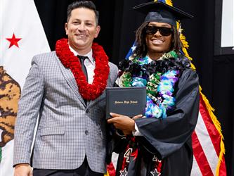 futures principal posing with graduating student