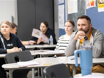 guests listening to speaker in class